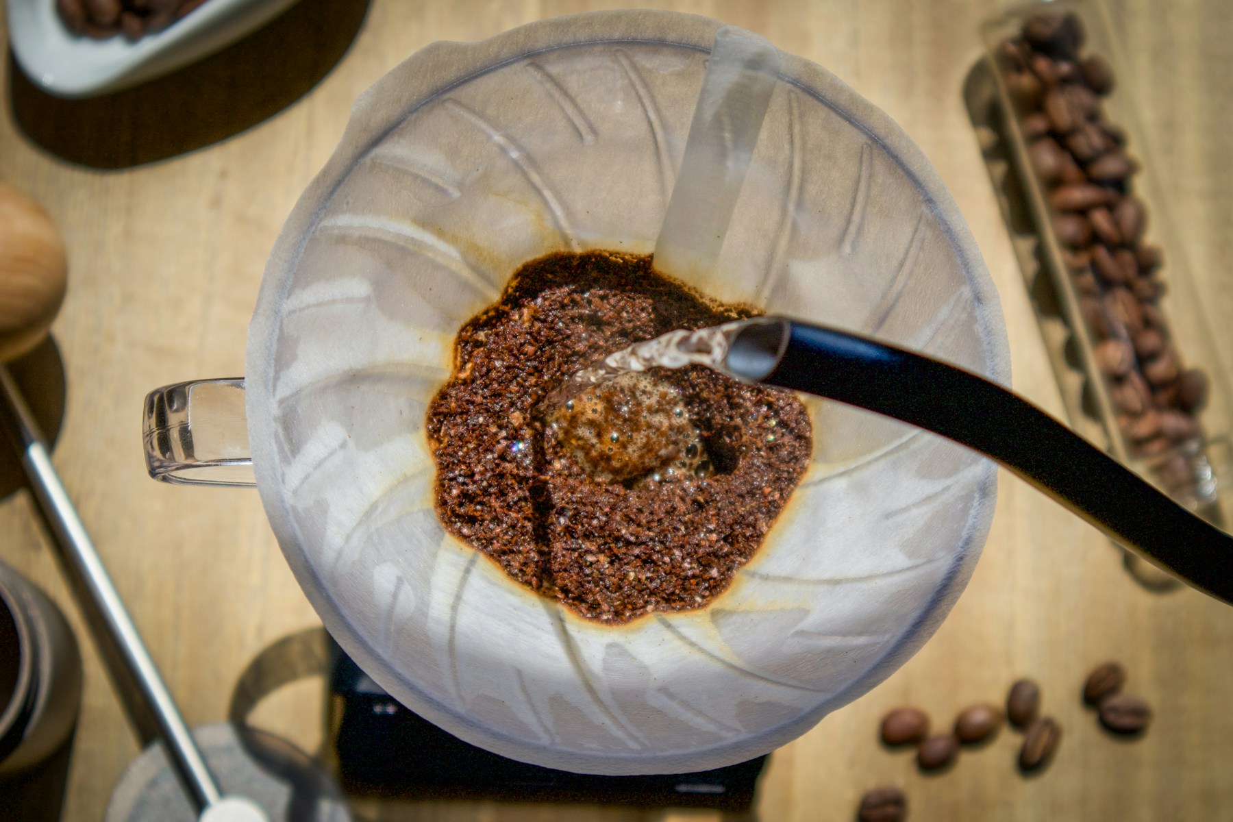 Hot water meeting freshly ground coffee in a pour-over